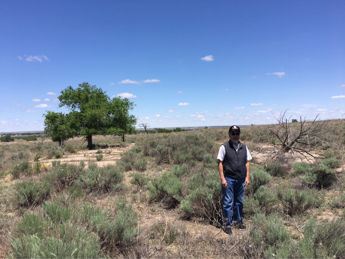 Dennis Otsuji, at the site of his birthplace at Amache Internment Camp. Jim's maps enabled him to show Dennis to the site of the barrack where he was born during WWII