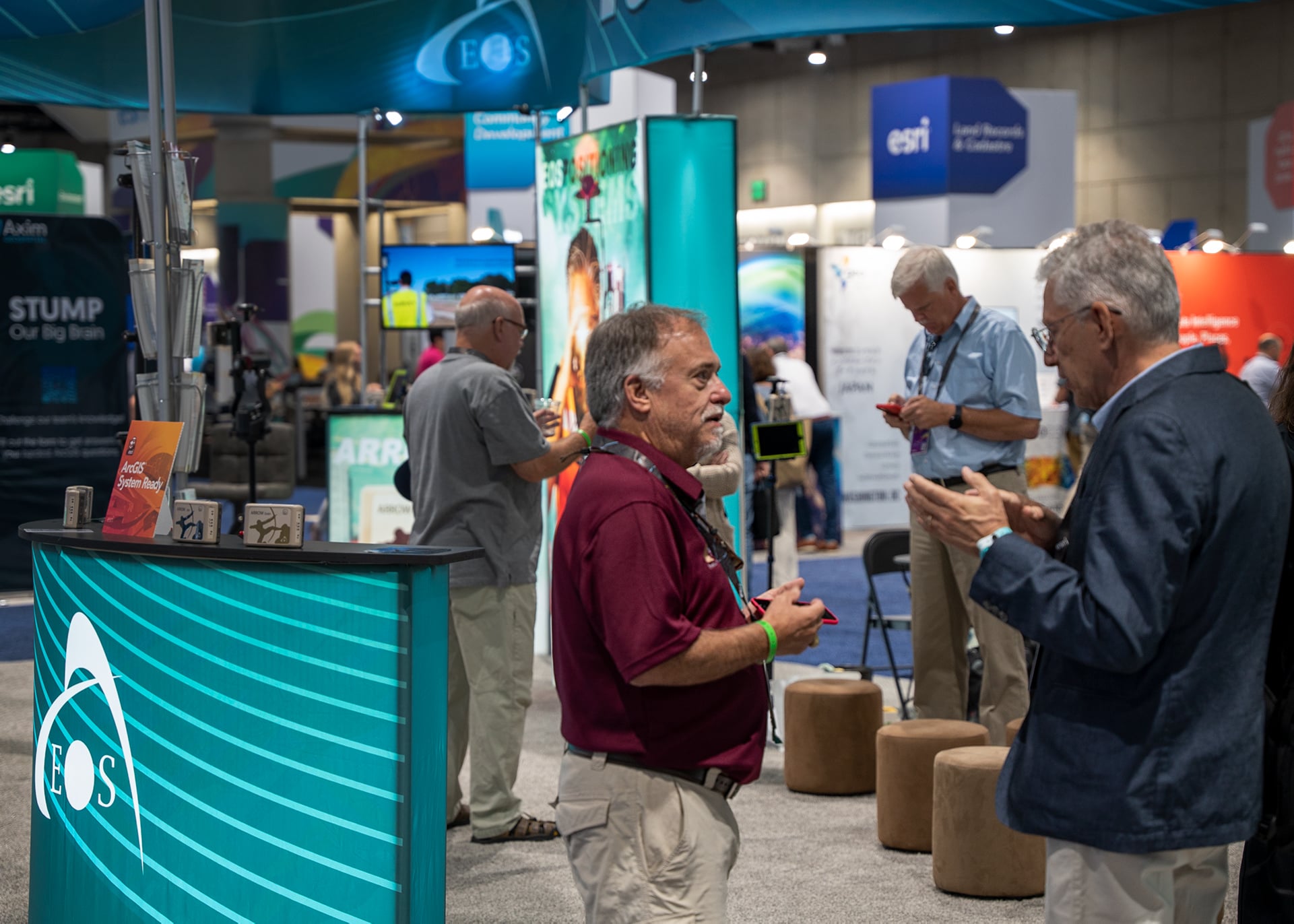 David Pritchard speaks to a customer at the Eos Esri UC booth