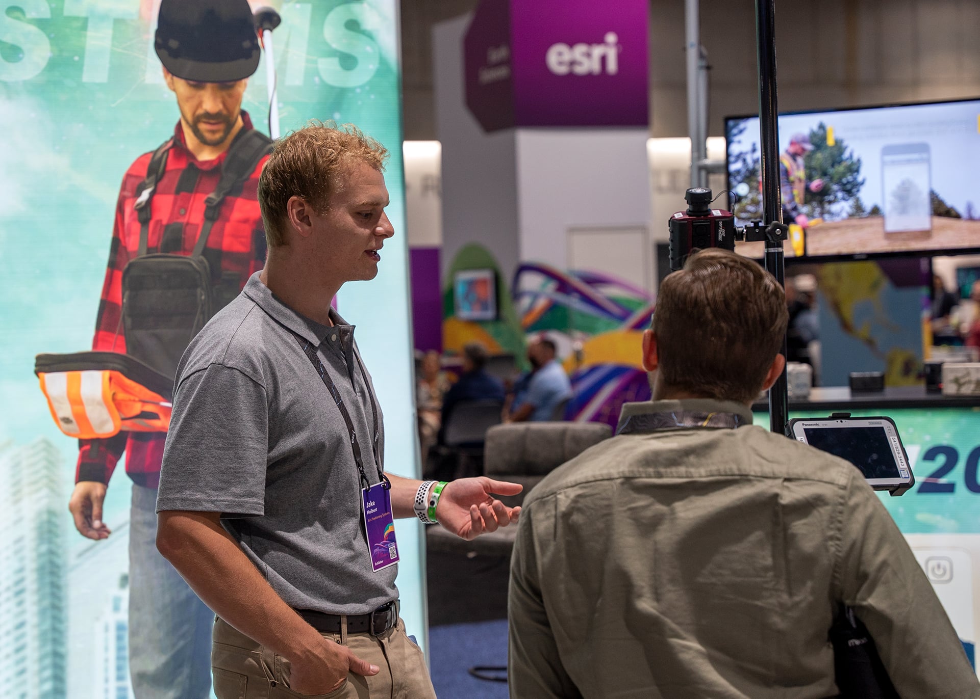 Jake Holbert Speaks to a Customer at the Esri UC Booth