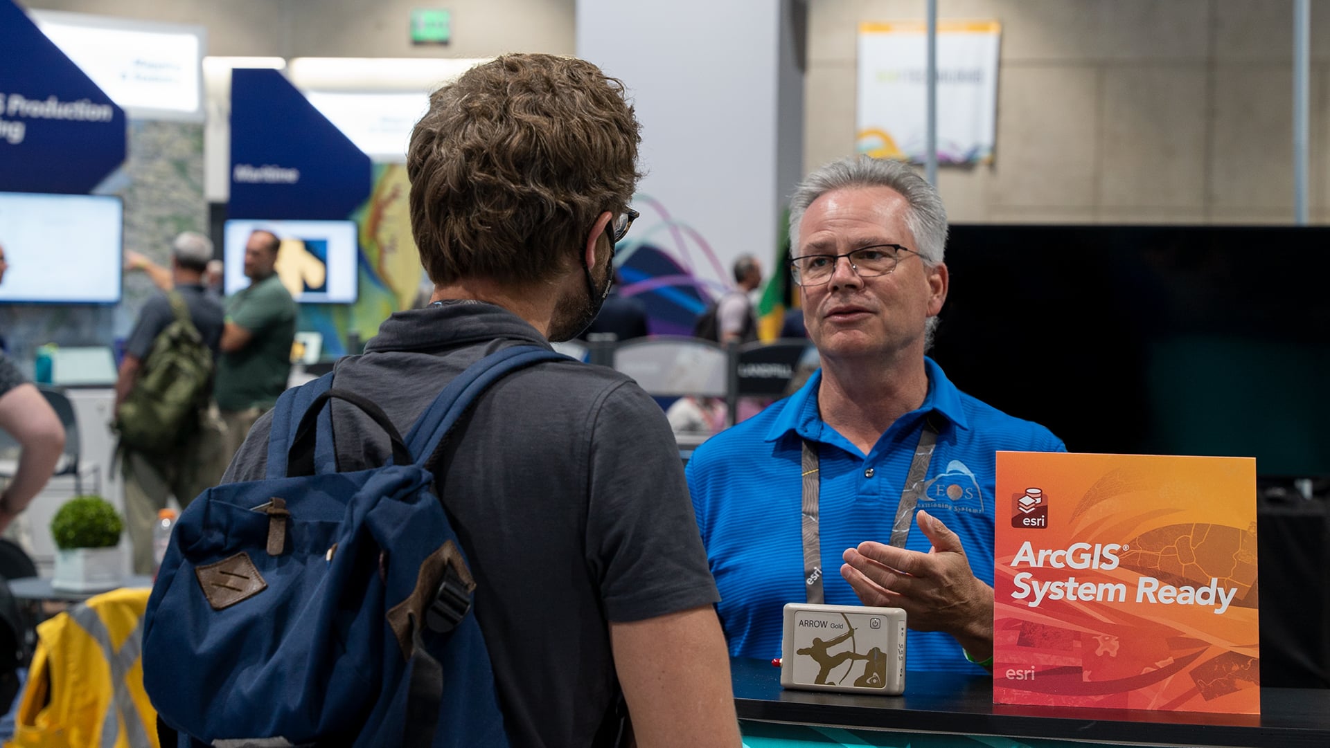 Steve Lawrence Talks to a Customer at the Eos Esri UC Booth