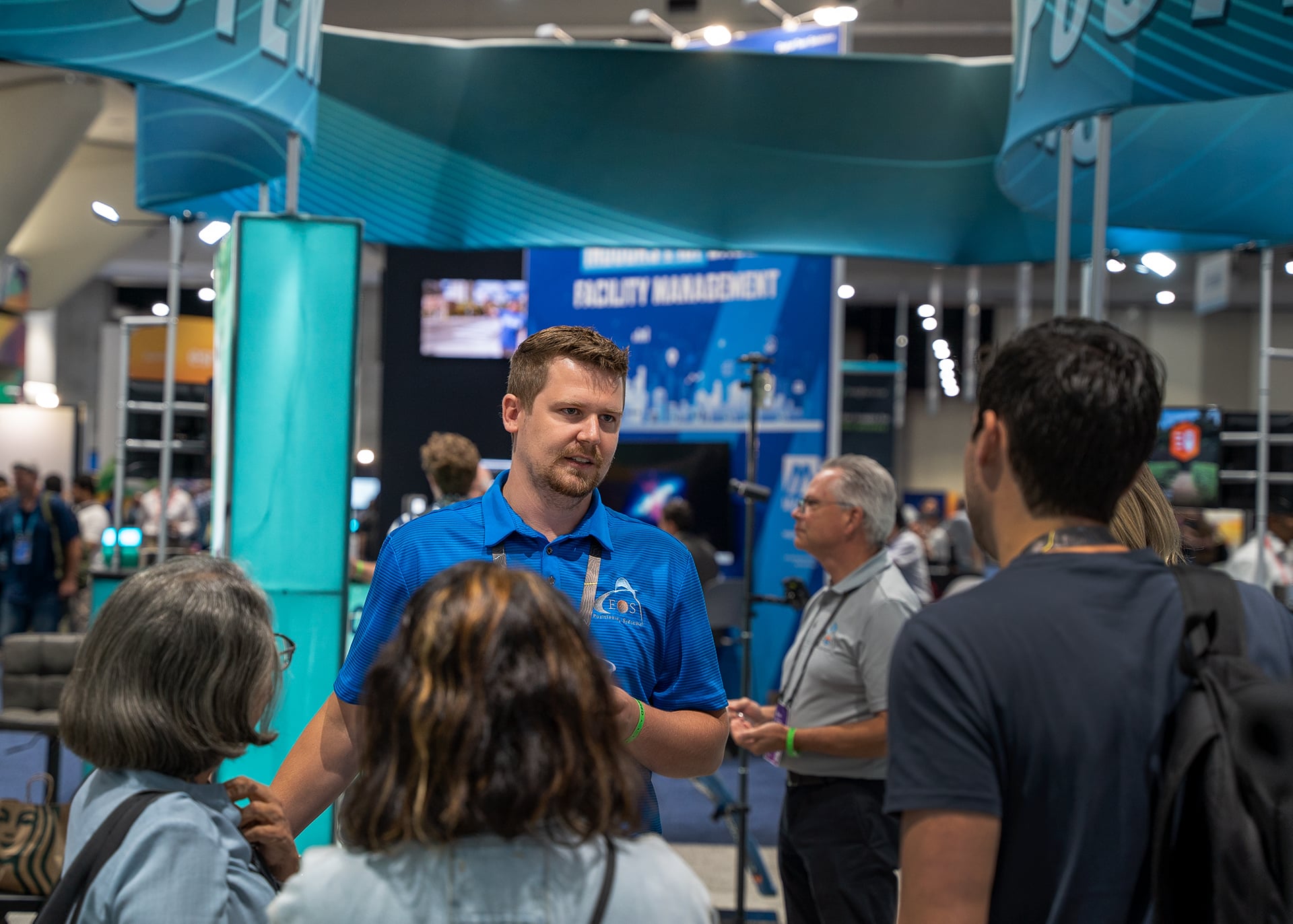 Tyler Gakstatter speaks to a customer at the Eos Esri UC booth