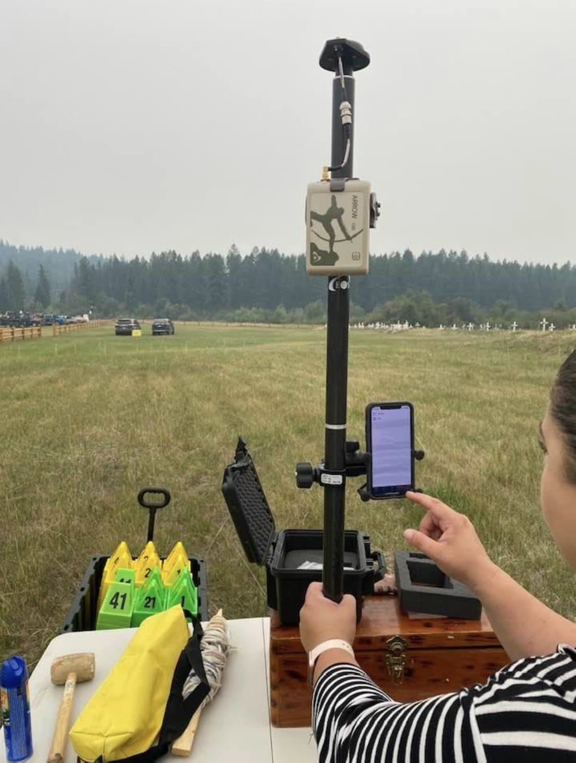 Indigenous Residential Schools - Sarah Beaulieu prepares an Arrow 100 GNSS receiver to map potential graves