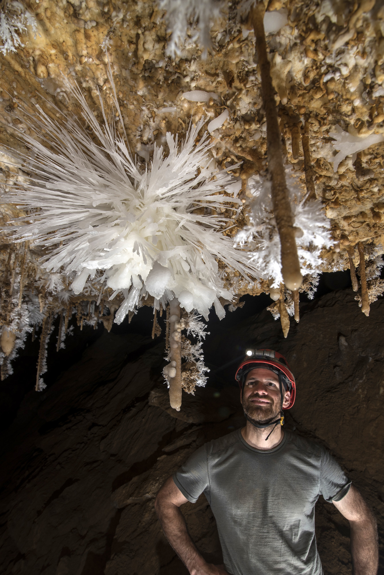 PESH cave explorer Mike Green examines an impressive anthodite formation in the San Agustín Sala Grande in Anthodite Hall. Anthodites are a rare crystalline mineral formation found only in certain caves. (Photo by Chris Higgins)