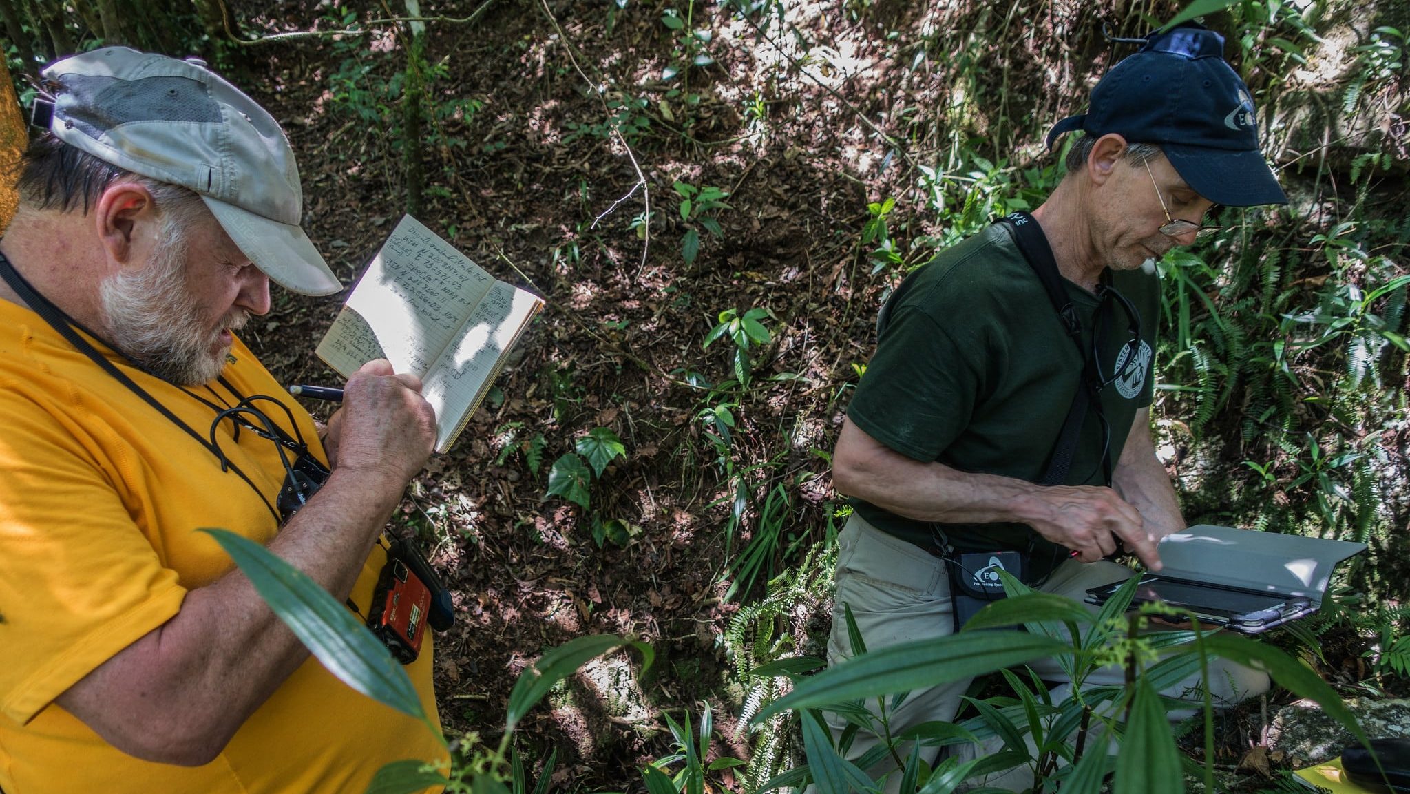 PESH explorer Jim Smith takes notes while Thomas Shifflett uses the Arrow 100 GNSS receiver for cave mapping to determine the coordinates of a cave entrance.