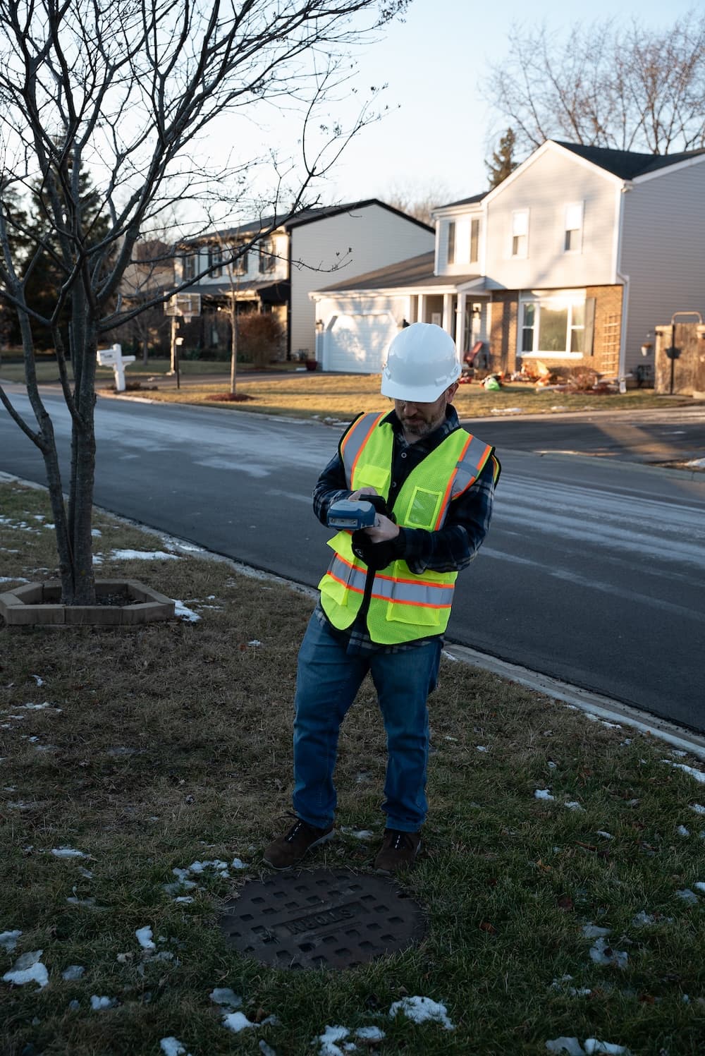 Invisible Range Pole being used by field worker while finding the position of a stormwater asset for mapping in ArcGIS Field Maps