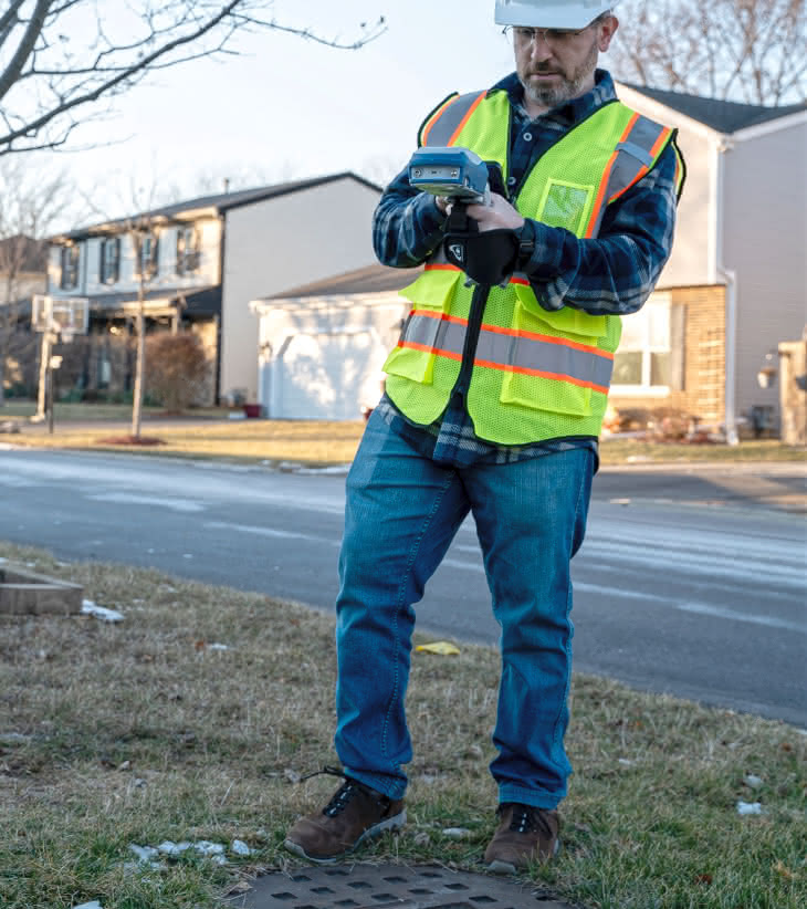 Invisible Range Pole mode is designed to continuously measure the X, Y, and Z position of the location of the ground or asset directly below the receiver. Seen here with field worker measuring stormwater manhole position