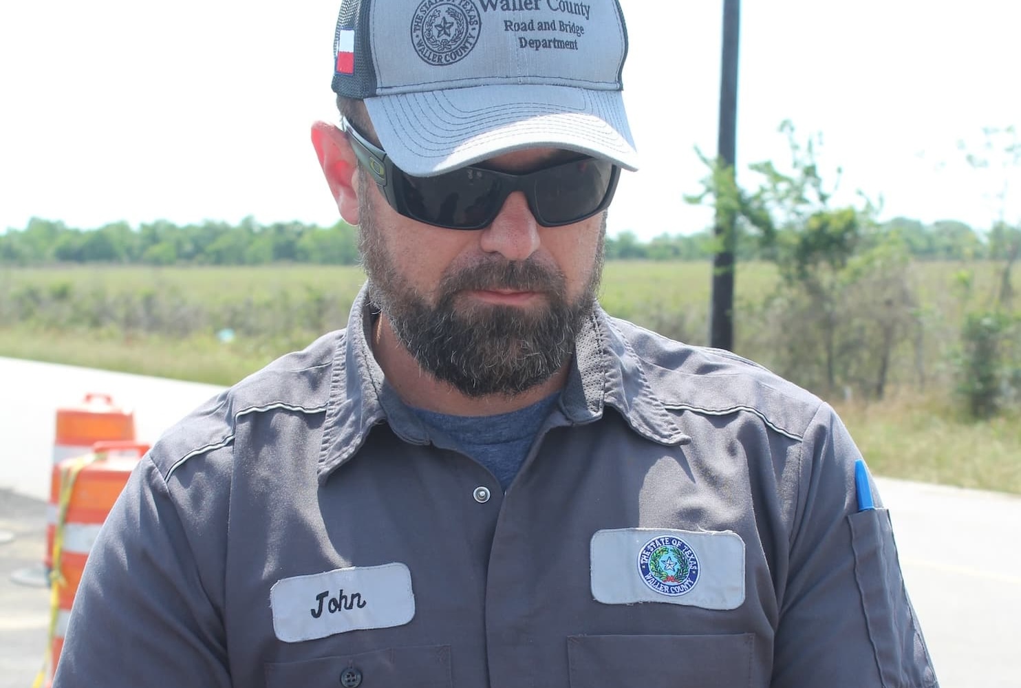 IMG_4601 copy John working in FM GIS Manager and 9-1-1 Coordinator John Murrell gets ArcGIS set up on his iPhone. (Credit: L. Sikes, Waller County Road and Bridge Department)