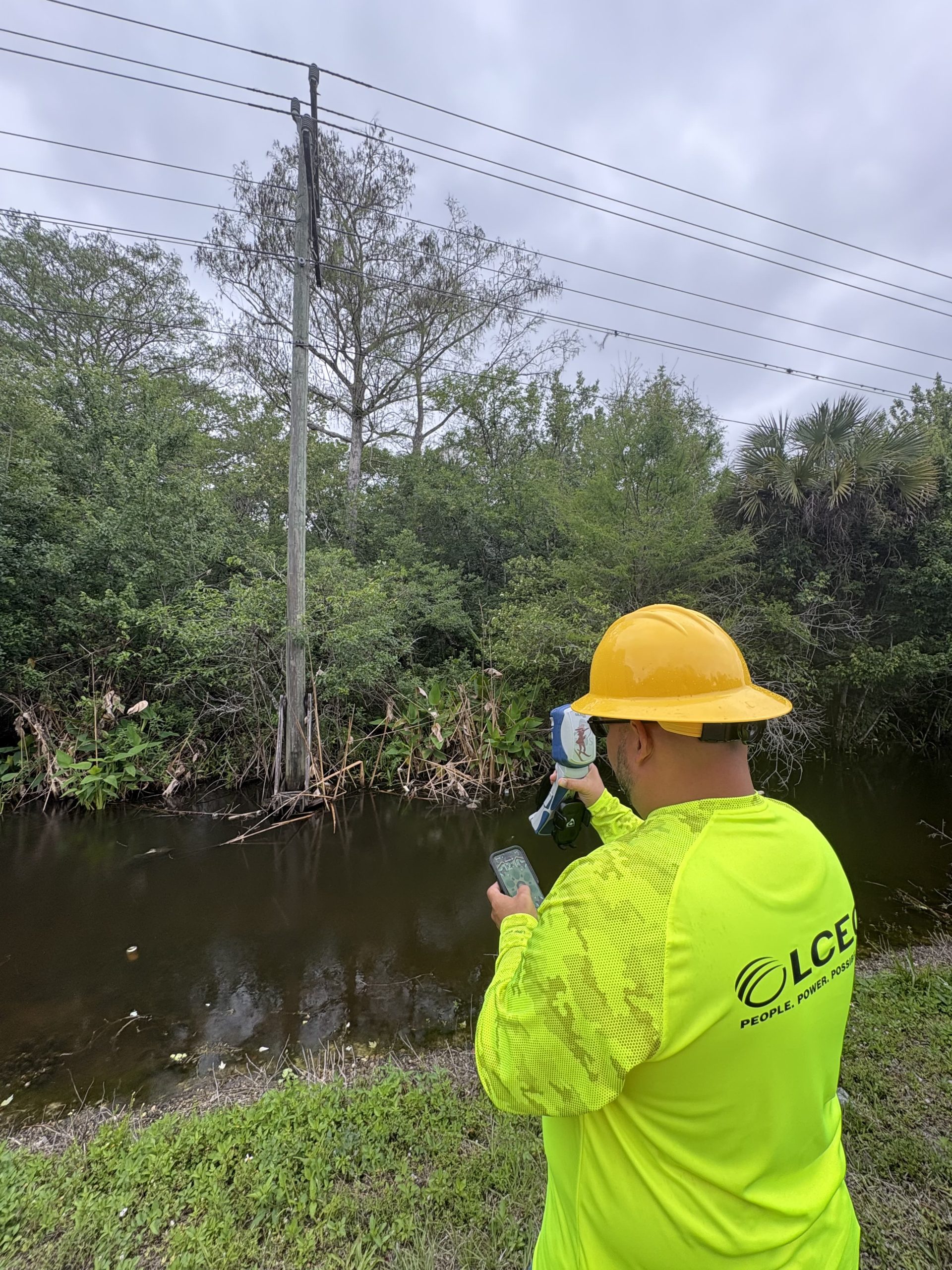 LCEC - GPS over water2 Lee County Electric Cooperative LCEC GIS Specialist Gus Otero maps electric utility assets across a canal using the Skadi Smart Handle GNSS with NISC mobile app
