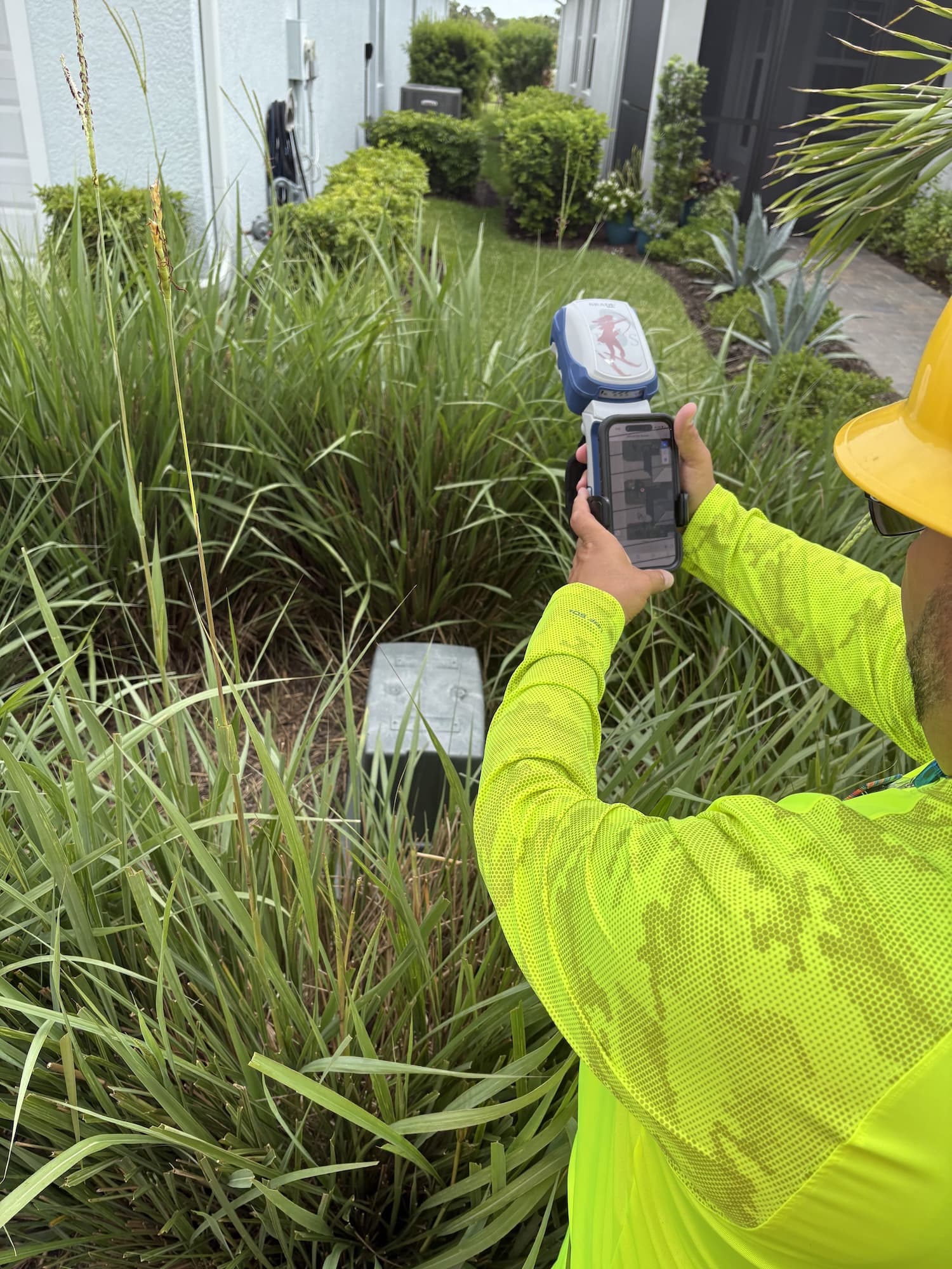 LCEC - PED in Bush3 Lee County Electric Cooperative LCEC GIS Specialist Gus Otero maps electric pedestal in bush using the Skadi Smart Handle GNSS with NISC mobile app
